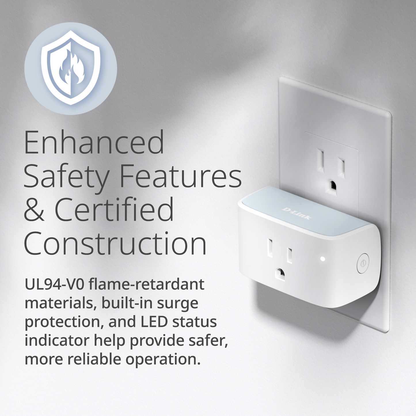 White electrical outlet with safety features text on a gray background